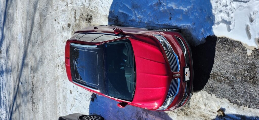 Rear view of the Lincoln MKX AWD rental with mountains behind, Summit Rental Car